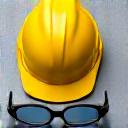Hard hat and safety glasses on a work bench