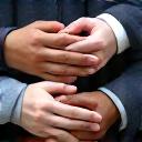 Diverse team hands stacked on top of each other, symbolizing teamwork and collaboration